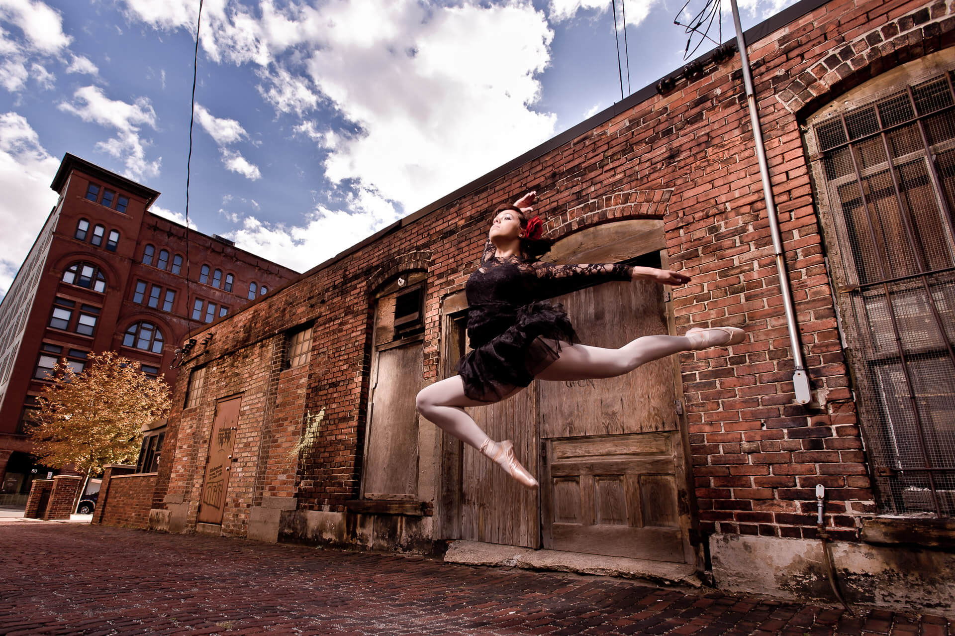 High school ballerina leaps in downtown Grand Rapids senior portrait photography